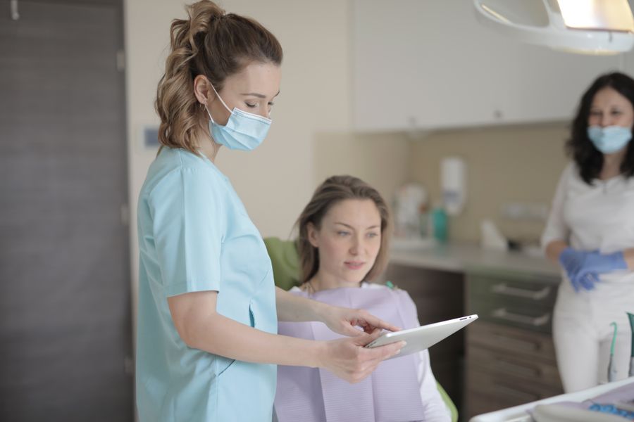 A healthcare professional reviewing patient information on a tablet