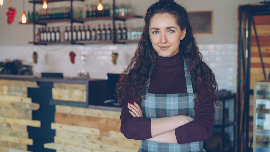 A small business owner standing confidently in their shop