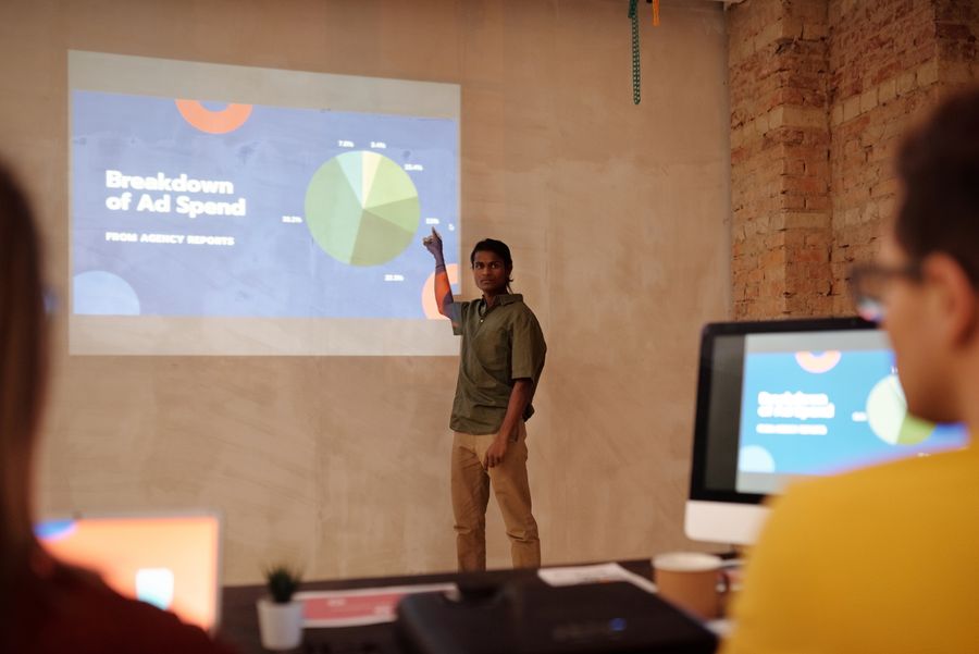 A marketer presenting an ad spend breakdown from a paid campaign report